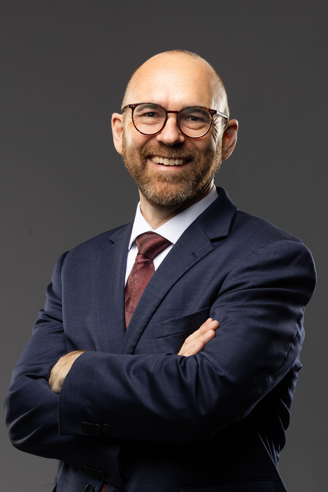 Harmen Steele smiling with his arms crossed