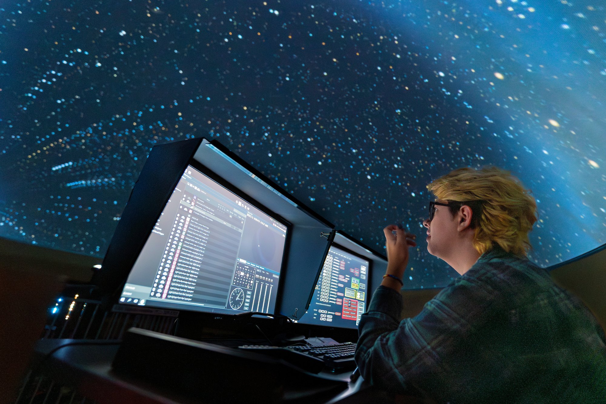 A University of Montana Student running the planetarium show “Sounds of the Ocean”.